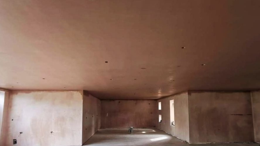 Large open room with every wall and the ceiling freshly skimmed