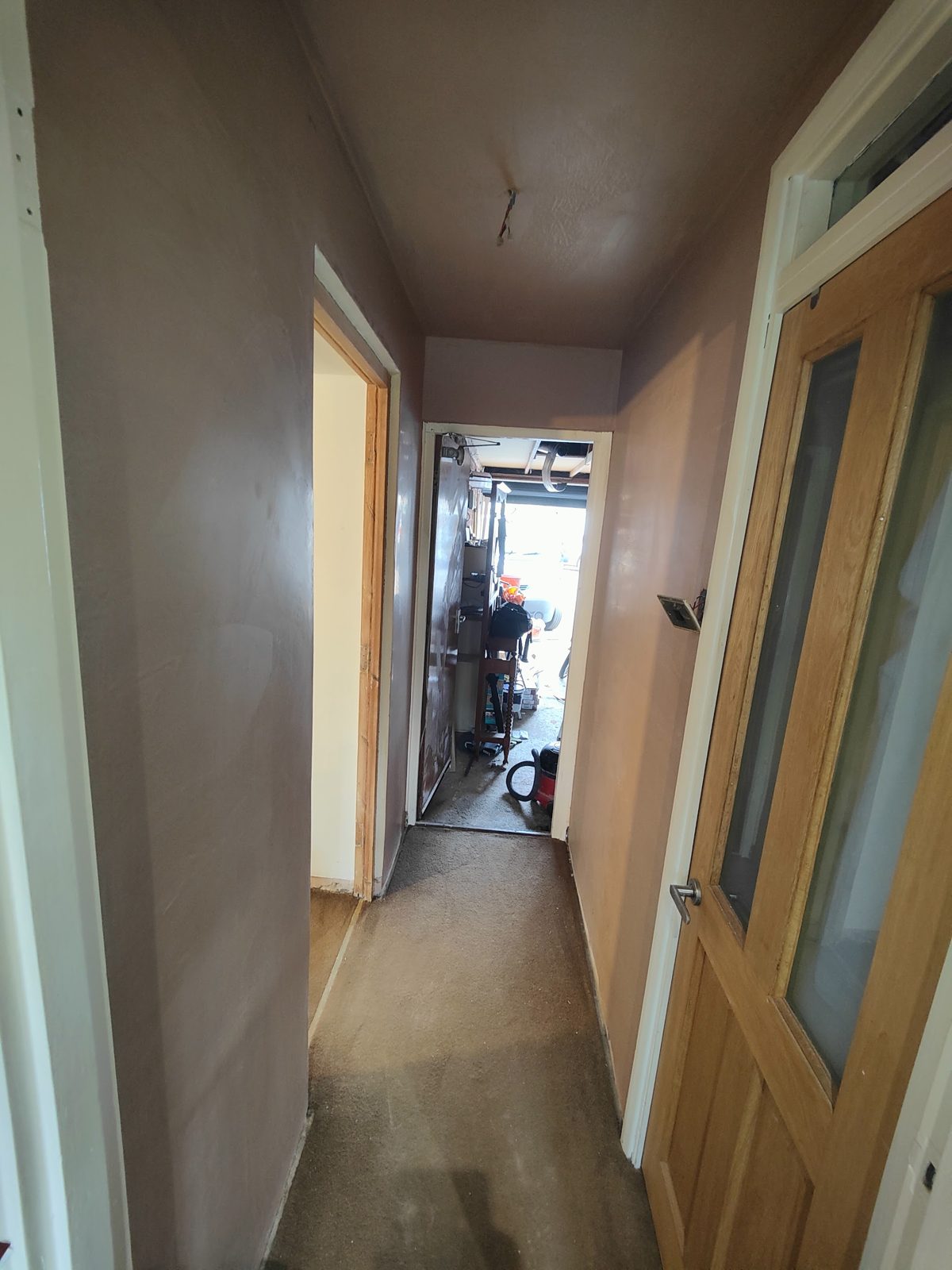 Narrow hallway with newly plastered walls